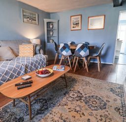 A living room with a coffee table and sofa at Delphinium Blakeney, Norfolk