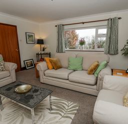 A living room with a sofa and coffee table at Blaenywawr near Lampeter