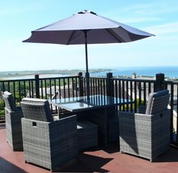 An outdoor patio with a table and chairs at Maesawel Studio in Llanfair