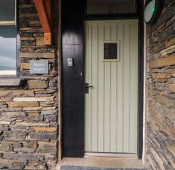 An entrance with a door and sign at Kelsick Heights Ambleside