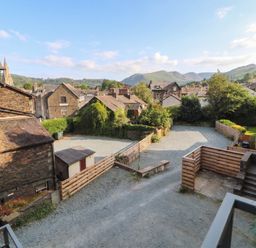 An outdoor area with buildings and mountains at Kelsick Heights in Ambleside