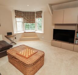 A living room with a coffee table and television at Kelsick Heights in Ambleside