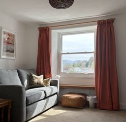 A living room with a sofa and window at Prospect Lodge in Portinscale