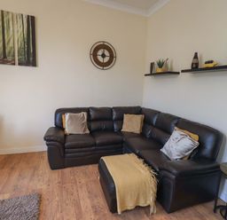 A living room with a sofa and shelves at St Johns View in Keswick