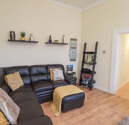 A living room with a sofa and shelves at St Johns View in Keswick