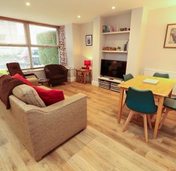 A living room with a sofa and television at Archers in Keswick