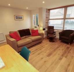A living room with a sofa and armchair at Archers in Keswick