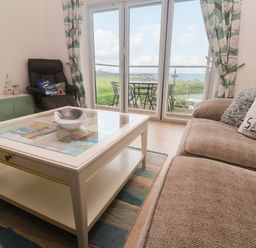 A living room with a coffee table and sofa at Ocean Seven in Newquay