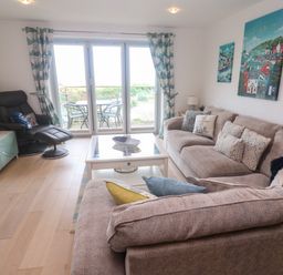 A living room with a sofa and coffee table at Ocean Seven in Newquay