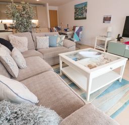 A living room with a coffee table and sofa at Ocean Seven in Newquay
