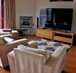 A living room with a sofa set and television at Boavista in Carnforth