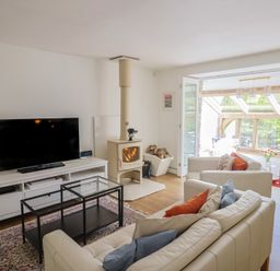 A living room with a television and sofa at Pottery Barn in Branscombe