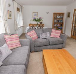A living room with two gray sofas and a wooden coffee table at The Dene in Betws-y-Coed