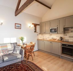 A kitchen with seating area and dining table at Miners Dry, Gulworthy, near Tavistock