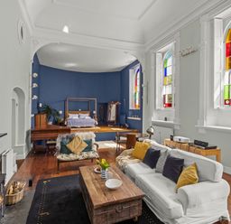 A living room with a sofa coffee table and piano at The Music Room Aveton Gifford