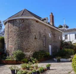 An outdoor area with stone walls and potted plants at The Music Room near Aveton Gifford