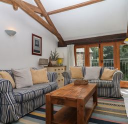 A living room with sofas and a coffee table at Fixit Cottage in Kingsbridge