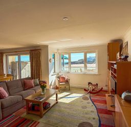 A living room with a sofa, coffee table and dining area at 5 Burgh Island Causeway Bigbury-on-Sea