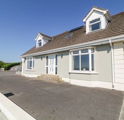 A detached house with a tiled roof and driveway in a rural setting at Tullyally in Redcastle