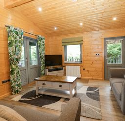 A living room with a sofa and television at Oak Lodge Pennington near Ulverston