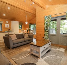 A living room with a sofa and coffee table at Oak Lodge Pennington near Ulverston