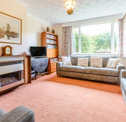 A living room with a sofa set a fireplace a TV and a bookshelf at The Perks in Scarborough