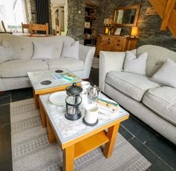 A living room with sofas and a coffee table at Garreg Ddu in Blaenau Ffestiniog