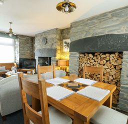 A dining room with a wooden table and chairs at Garreg Ddu in Blaenau Ffestiniog