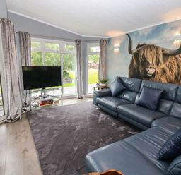 A living room with a sofa and television at 16 Badgers Retreat in Richmond