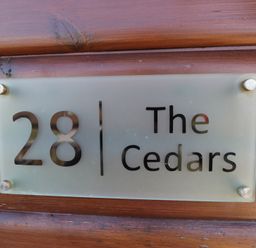 A name plate with the number 28 and The Cedars at The Cedars in South Lakeland Leisure Village