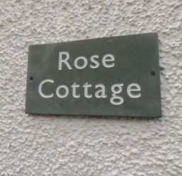 A sign reading Rose Cottage at Rose Cottage in Broughton-In-Furness