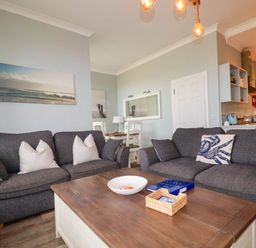 A living room with sofas and a coffee table at Seashore House in Porth