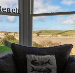 A living room with a view of the beach at Seashore House in Porth