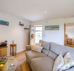 A living room with a sofa and coffee table at Cawsand in Tideford