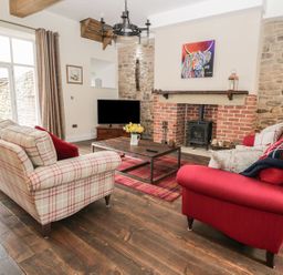 A living room with sofas and a coffee table at The Turnip Barn in 