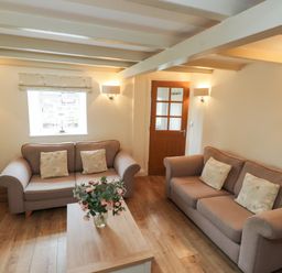 A living room with two sofas and a coffee table at Tan Y Goeden in Morfa Nefyn