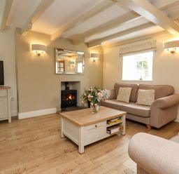 A living room with a sofa and television at Tan Y Goeden in Morfa Nefyn
