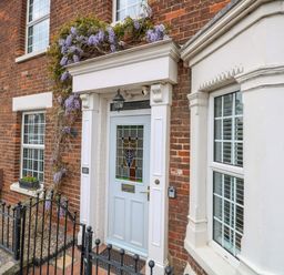 A front door with a window and flowers at Springfield in Hempton near Fakenham