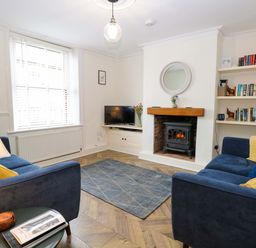 A living room with a sofa and television at Springfield in Hempton near Fakenham