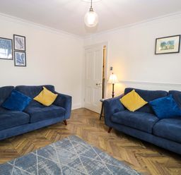 A living room with two sofas and a lamp at Springfield in Hempton near Fakenham