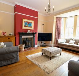 A living room with sofas and a television at Tilly's Retreat in Hunstanton