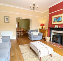 A living room with a sofa and fireplace at Tilly's Retreat in Hunstanton