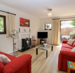 A living room with a sofa and television at Lowbrook Cottage Dickleburgh near Diss