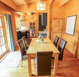 A dining room with a table and chairs at Tythe Lodge – Hot Tub Retreat in Rural Lincolnshire | Family-Friendly Lodge Near Heckington