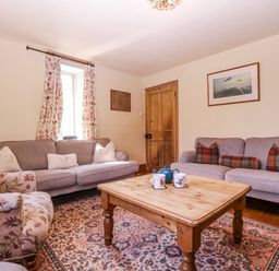 A living room with a coffee table and sofas at Elm View Chipping Campden