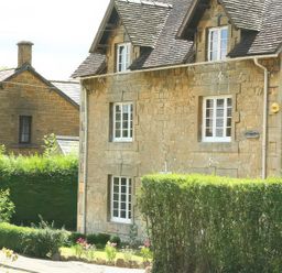 Stone house with windows and roof beside garden at Elm View Chipping Campden