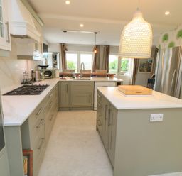 A kitchen with a large island and stainless steel appliances at Fairview Cottage in Milton-Under-Wychwood