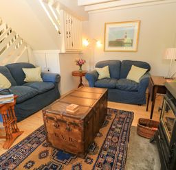 A living room with a coffee table and two sofas at Cider Press Cottage in Priston Village, Bath