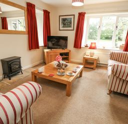 A living room with a sofa and coffee table at Droop Farm Cottage, Droop near Hazelbury Bryan