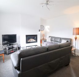 A living room with a television and fireplace at Arnant in Dolgellau